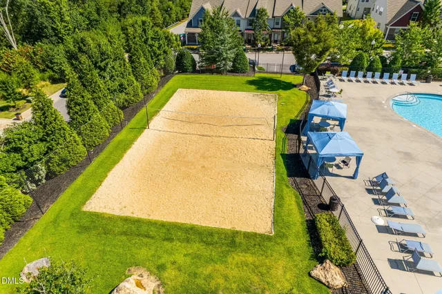 an aerial view of a swimming pool with a patio