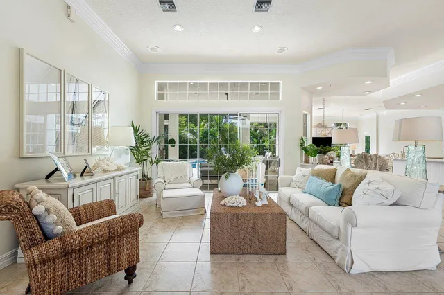 a living room with furniture potted plant and a bathroom