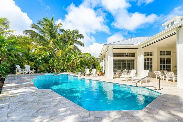 a view of a house with swimming pool and a yard