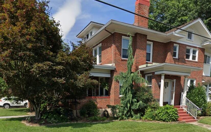 a front view of a house with garden