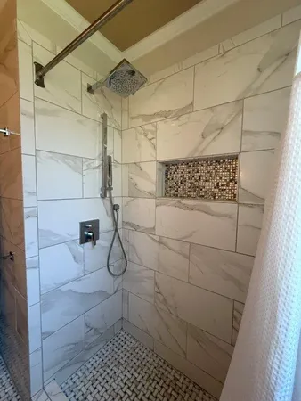 an empty room with wooden floor fireplace and windows