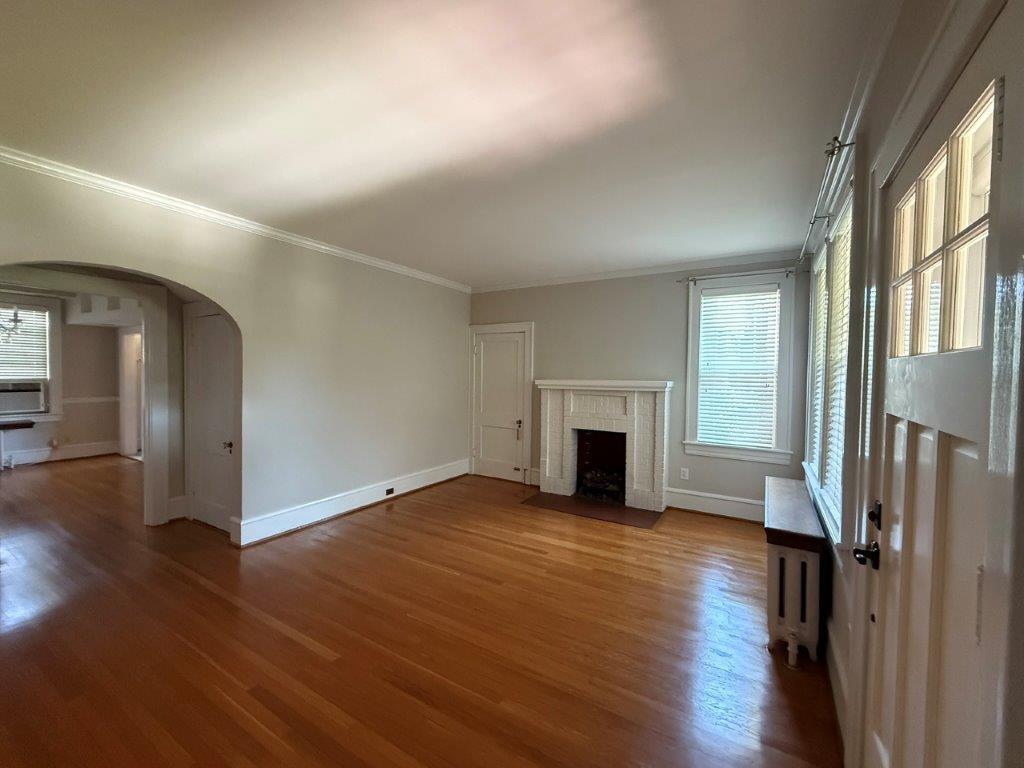 1901 Avon Road Southwest, Unit LOWR Roanoke, VA 24015 - Photo 11 of 31 an empty room with wooden floor fireplace and windows
