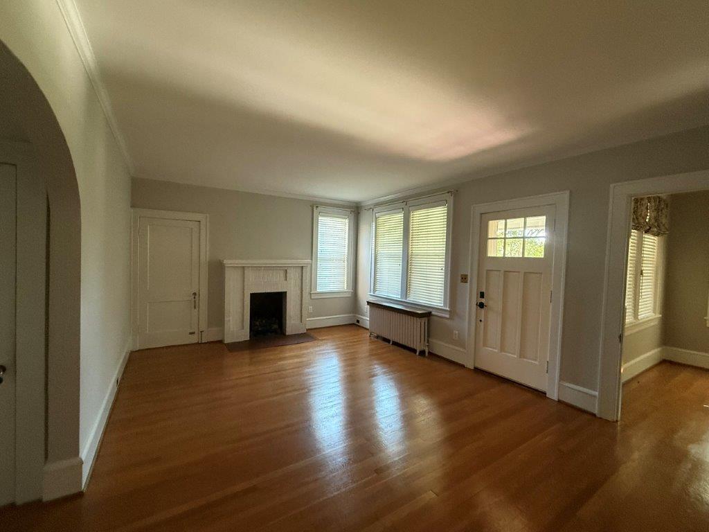1901 Avon Road Southwest, Unit LOWR Roanoke, VA 24015 - Photo 12 of 31 an empty room with wooden floor fireplace and windows