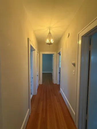 a view of a livingroom with wooden floor and a large window