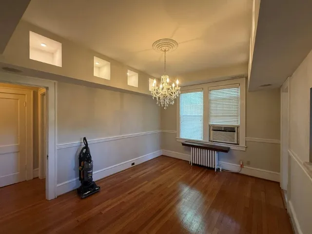 a view of a room with wooden floor and windows
