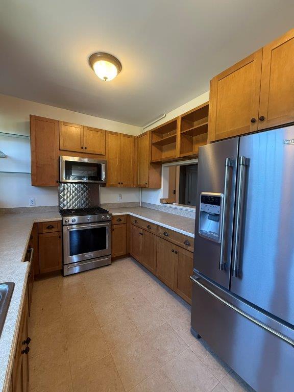 1901 Avon Road Southwest, Unit LOWR Roanoke, VA 24015 - Photo 17 of 31 a kitchen with granite countertop a refrigerator and a stove top oven