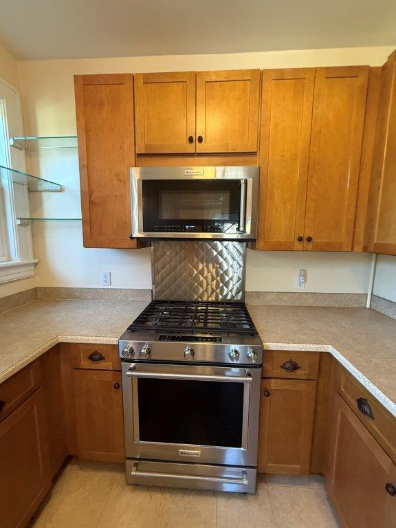 1901 Avon Road Southwest, Unit LOWR Roanoke, VA 24015 - Photo 18 of 31 a kitchen with granite countertop a stove and a microwave