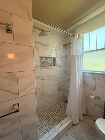 a bathroom with a shower and a toilet