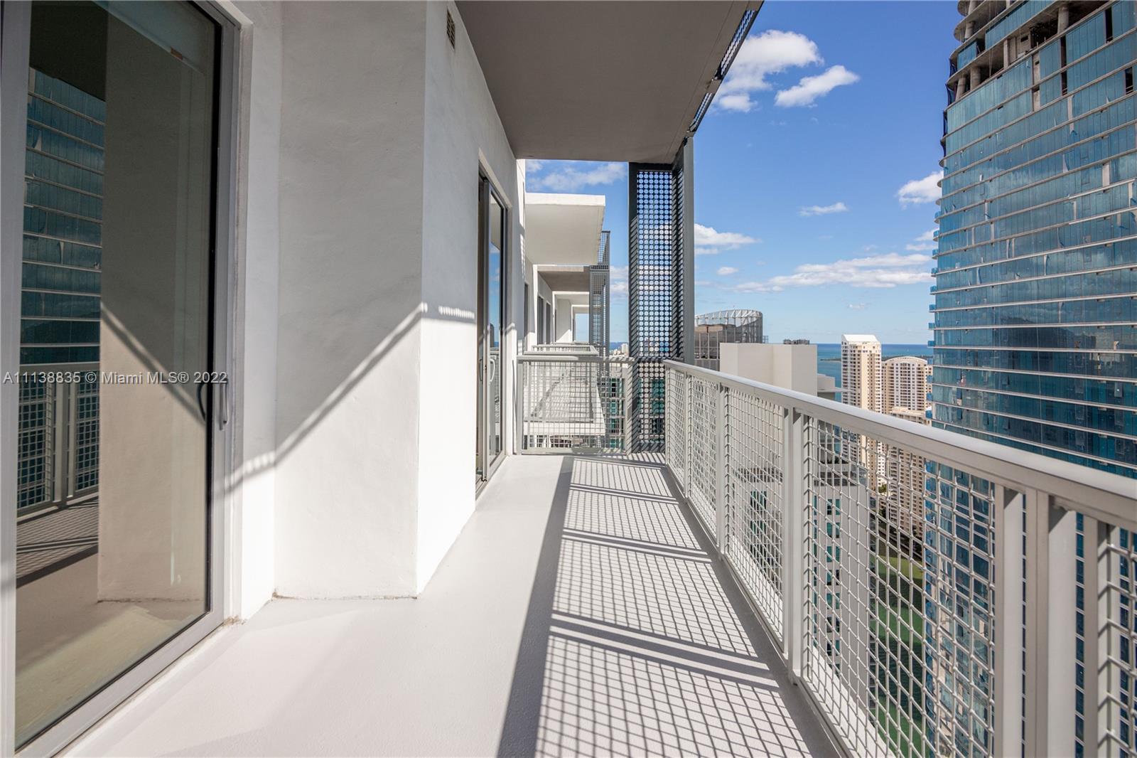 340 Southeast 3rd Street, Unit PH4 Miami, FL 33131 - Photo 17 of 62 a view of a balcony with wooden floor