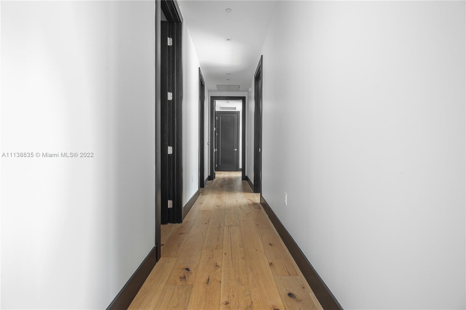 340 Southeast 3rd Street, Unit PH4 Miami, FL 33131 - Photo 36 of 62 a view of a hallway with wooden floor