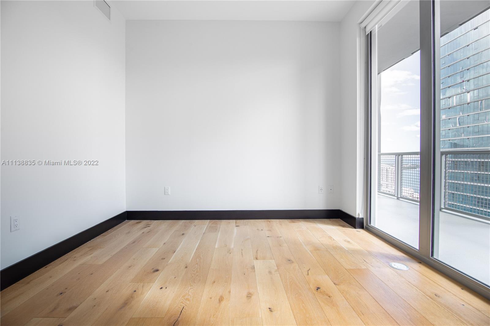 340 Southeast 3rd Street, Unit PH4 Miami, FL 33131 - Photo 39 of 62 a view of an empty room and wooden floor