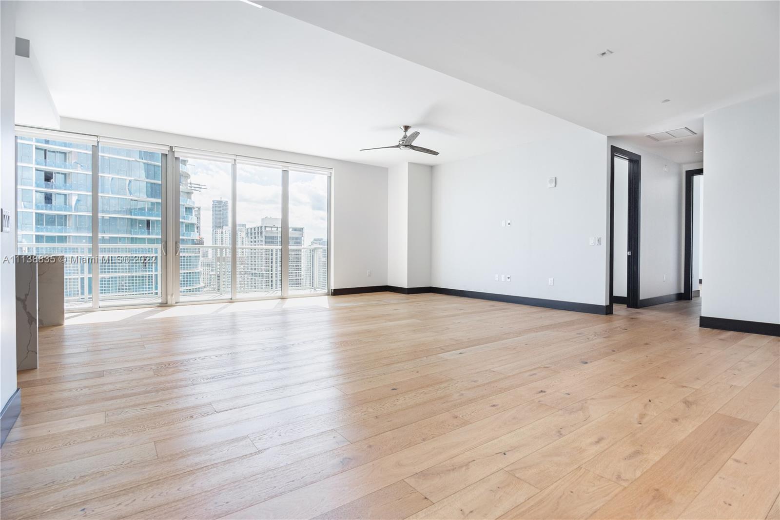 340 Southeast 3rd Street, Unit PH4 Miami, FL 33131 - Photo 4 of 62 wooden floor in an empty room with a window
