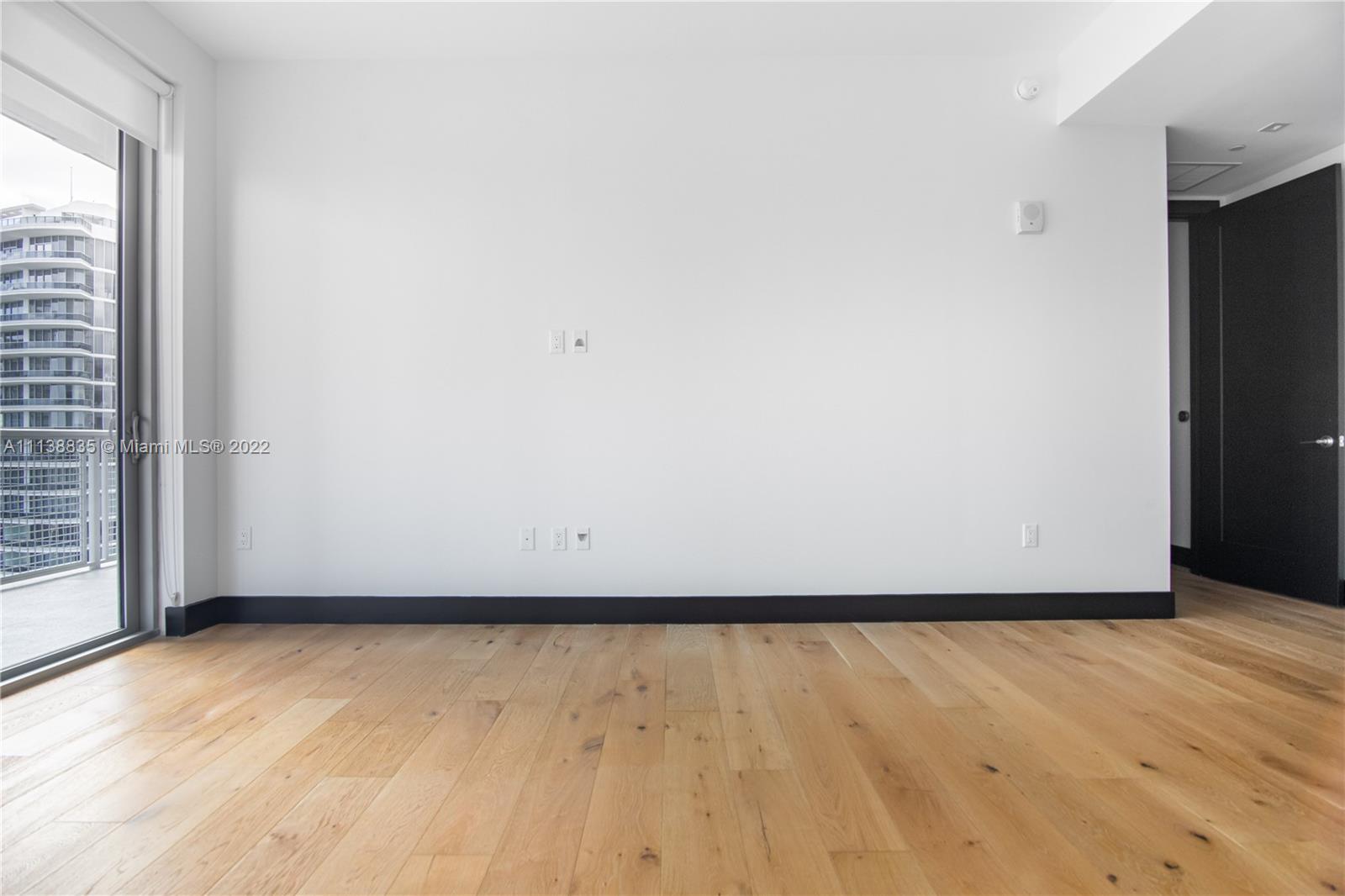 340 Southeast 3rd Street, Unit PH4 Miami, FL 33131 - Photo 49 of 62 a view of an empty room and wooden floor
