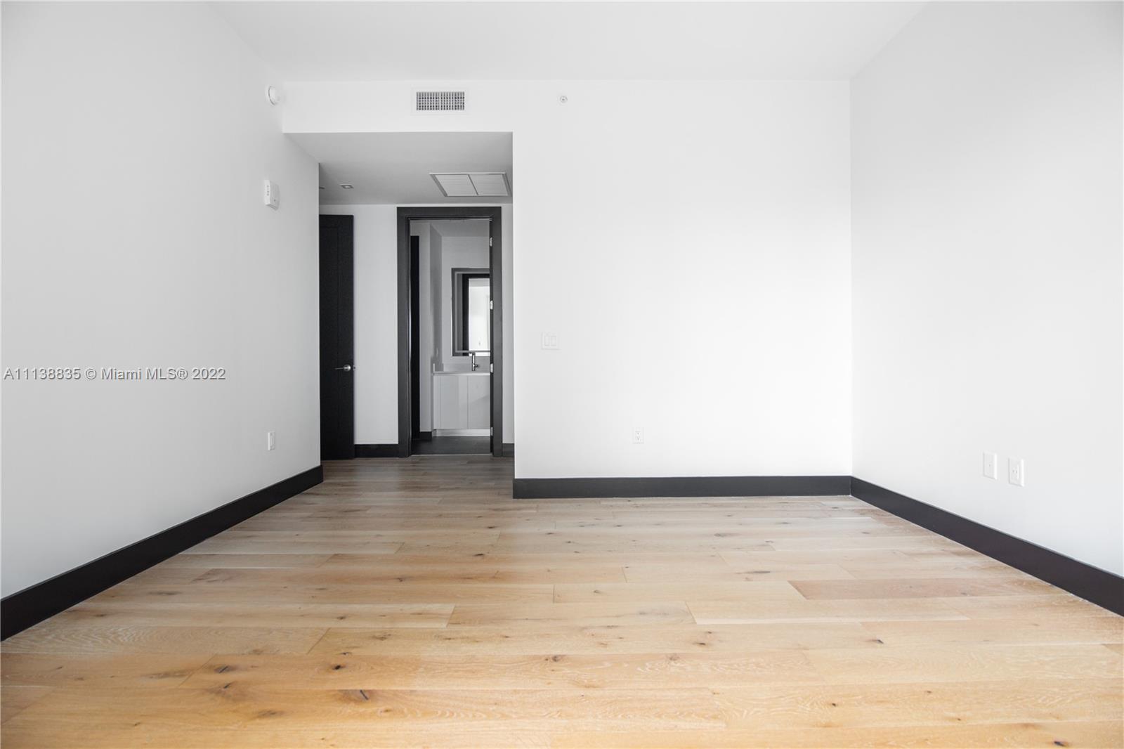 340 Southeast 3rd Street, Unit PH4 Miami, FL 33131 - Photo 50 of 62 a view of a hallway with wooden floor