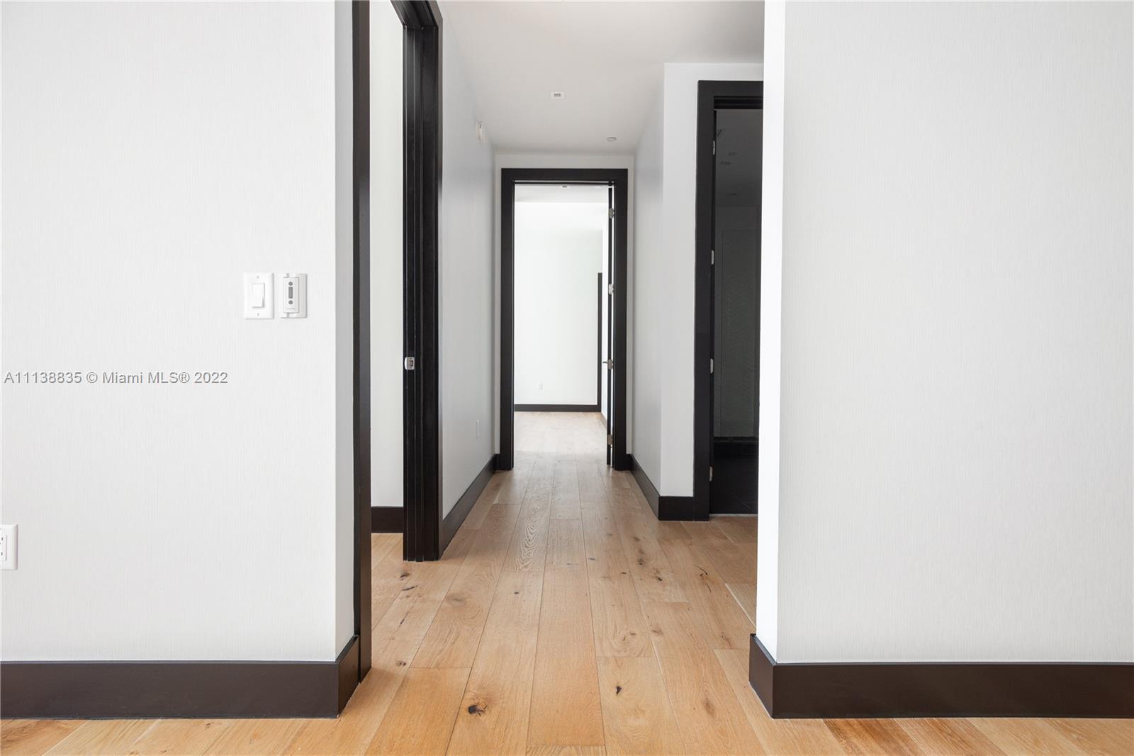 340 Southeast 3rd Street, Unit PH4 Miami, FL 33131 - Photo 8 of 62 a view of a hallway with wooden floor
