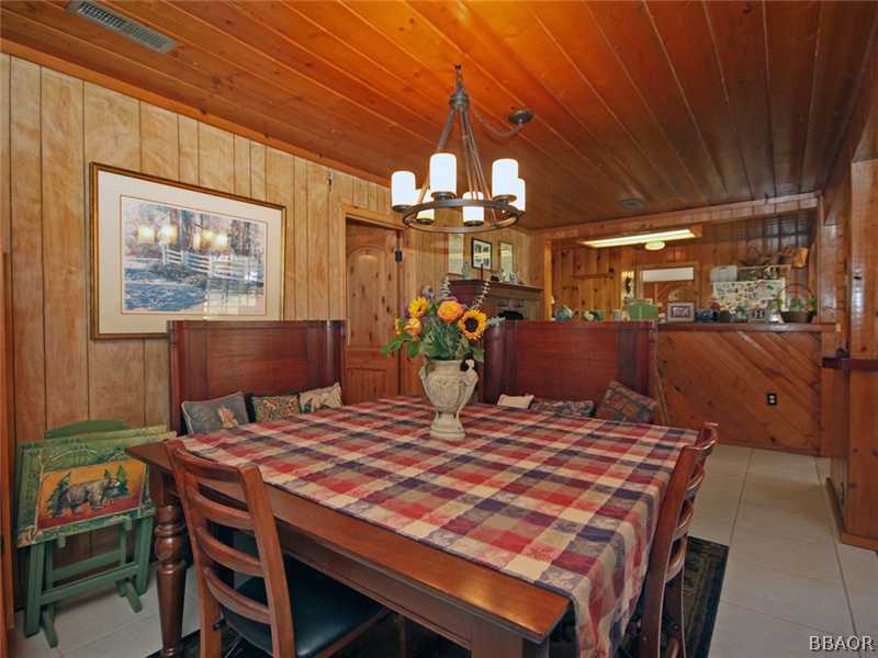 1004 Canyon Road Fawnskin, CA 92333 - Photo 13 of 25 a view of a dining room with furniture and chandelier
