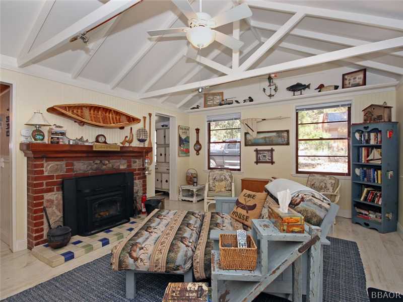 1004 Canyon Road Fawnskin, CA 92333 - Photo 15 of 25 a living room with furniture a fireplace and a table
