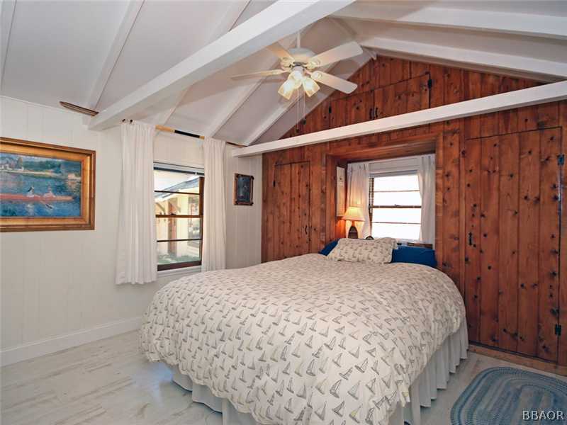 1004 Canyon Road Fawnskin, CA 92333 - Photo 17 of 25 a bedroom with a large bed and a window