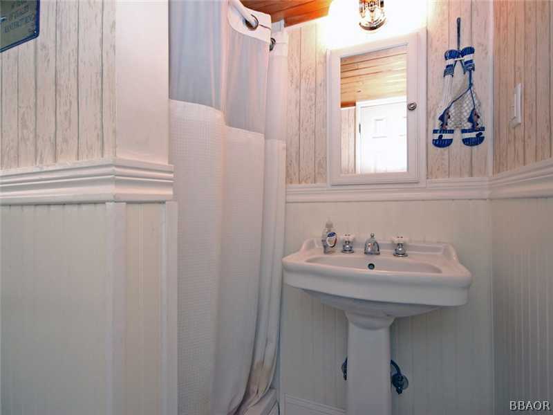 1004 Canyon Road Fawnskin, CA 92333 - Photo 18 of 25 a bathroom with a sink a window and a mirror