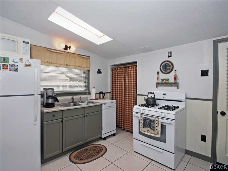 1004 Canyon Road Fawnskin, CA 92333 - Photo 21 of 25 a kitchen with stainless steel appliances a stove a sink and a refrigerator