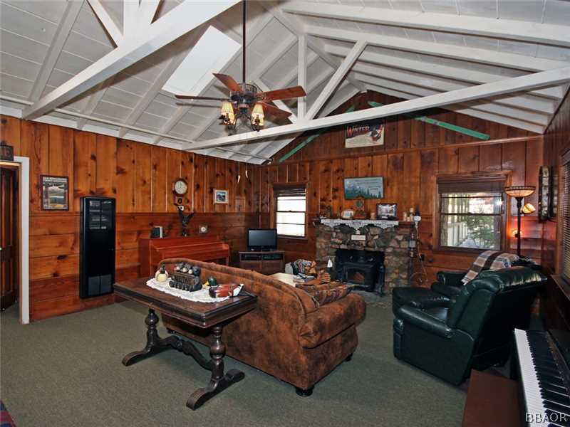 1004 Canyon Road Fawnskin, CA 92333 - Photo 7 of 25 a living room with furniture a ceiling fan and a rug