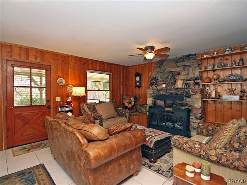 1004 Canyon Road Fawnskin, CA 92333 - Photo 10 of 25 a living room with furniture and a window