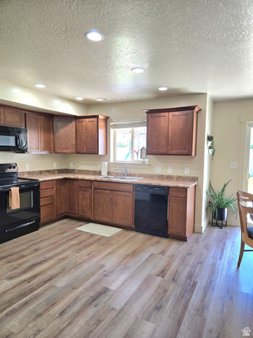 601 West 150 North, Unit 25 Springville, UT 84663 - Photo 7 of 29 Kitchen featuring wood-finish flooring, dark wood cabinetry, and neutral countertops