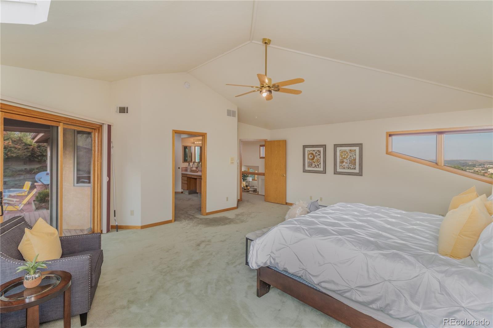 265 Bellevue Drive Boulder, CO 80302 - Photo 20 of 32 a bedroom with a bed and a chandelier