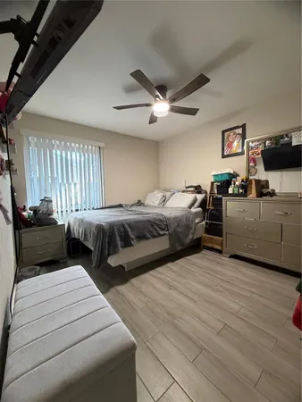 a bedroom with two beds and a chandelier