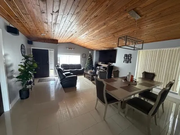 a living room with furniture and flowers