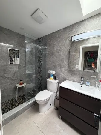 a bathroom with a sink toilet and shower