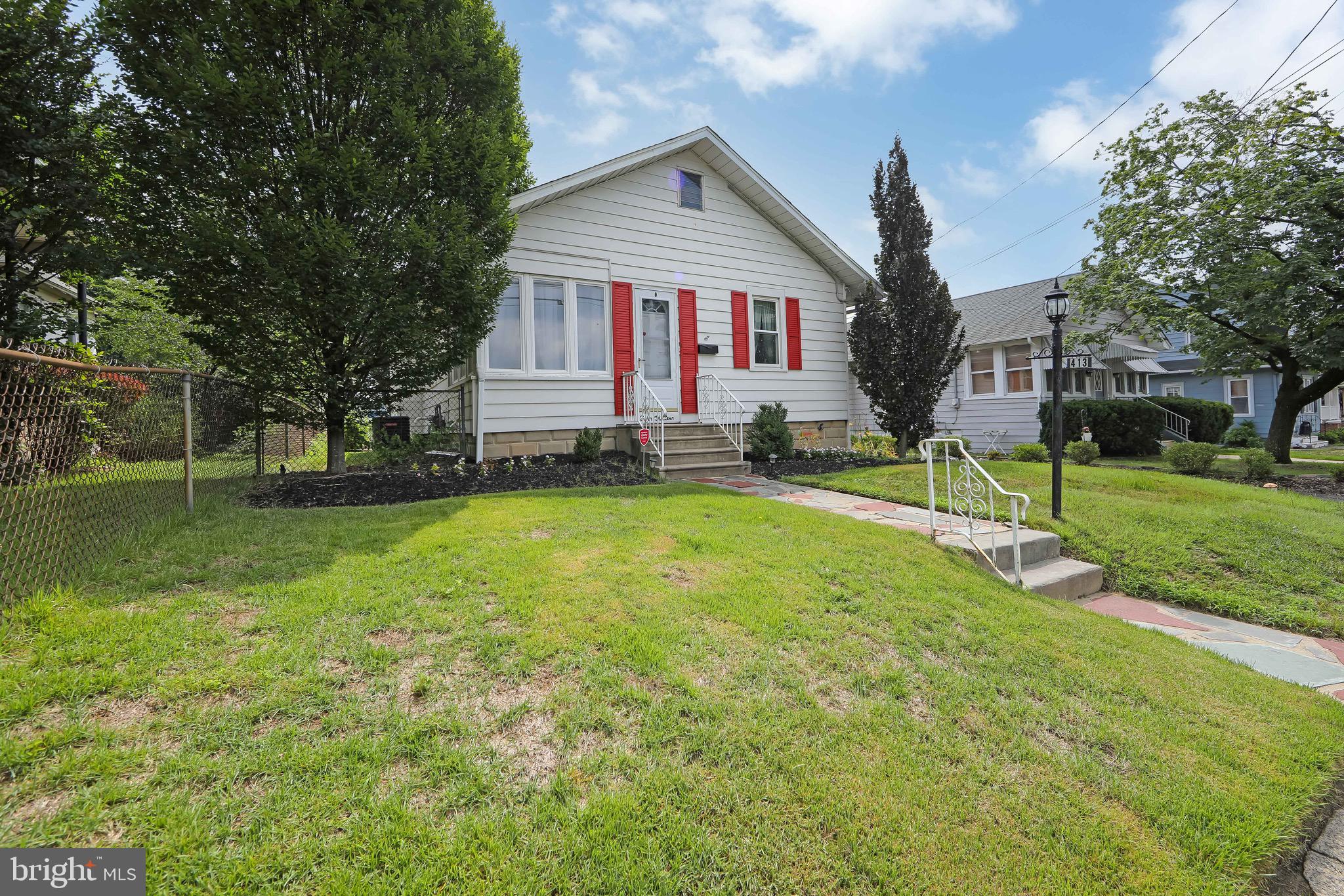 413 North Warwick Road Magnolia, NJ 08049 - Photo 3 of 40 a front view of a house with a yard