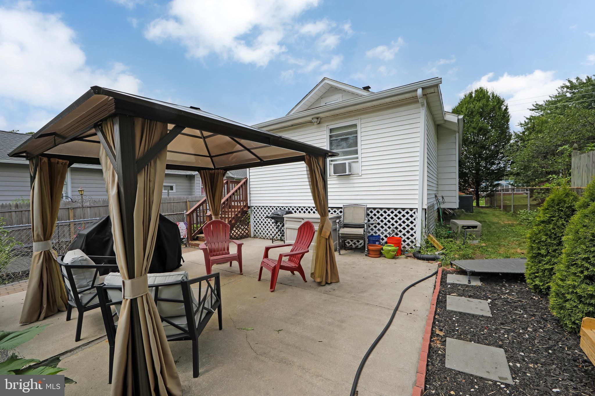 413 North Warwick Road Magnolia, NJ 08049 - Photo 33 of 40 a backyard of a house with table and chairs