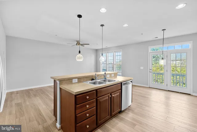 a kitchen with a granite countertop sink and wooden floor