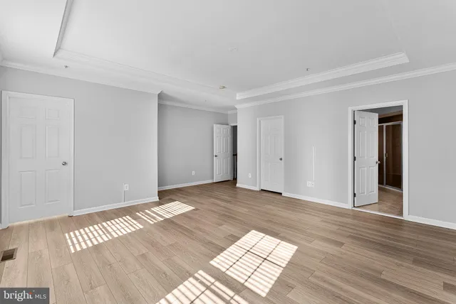 a view of an empty room and wooden floor