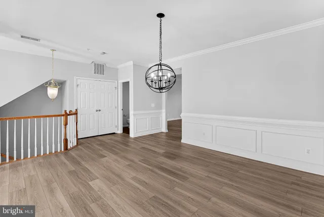 a view of a room with wooden floor fan and window