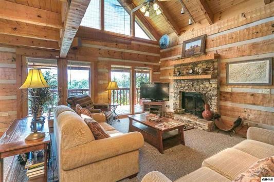 1758 Bluff Ridge Road Sevierville, TN 37876 - Photo 3 of 13 a living room with furniture a fireplace and a floor to ceiling window
