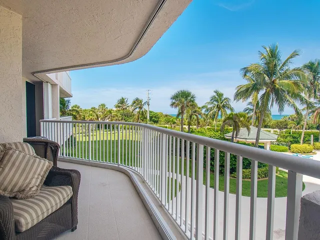 a view of a balcony with wooden floor and seating space