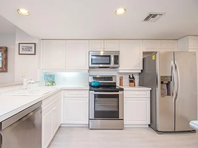 a kitchen with a sink and stainless steel appliances