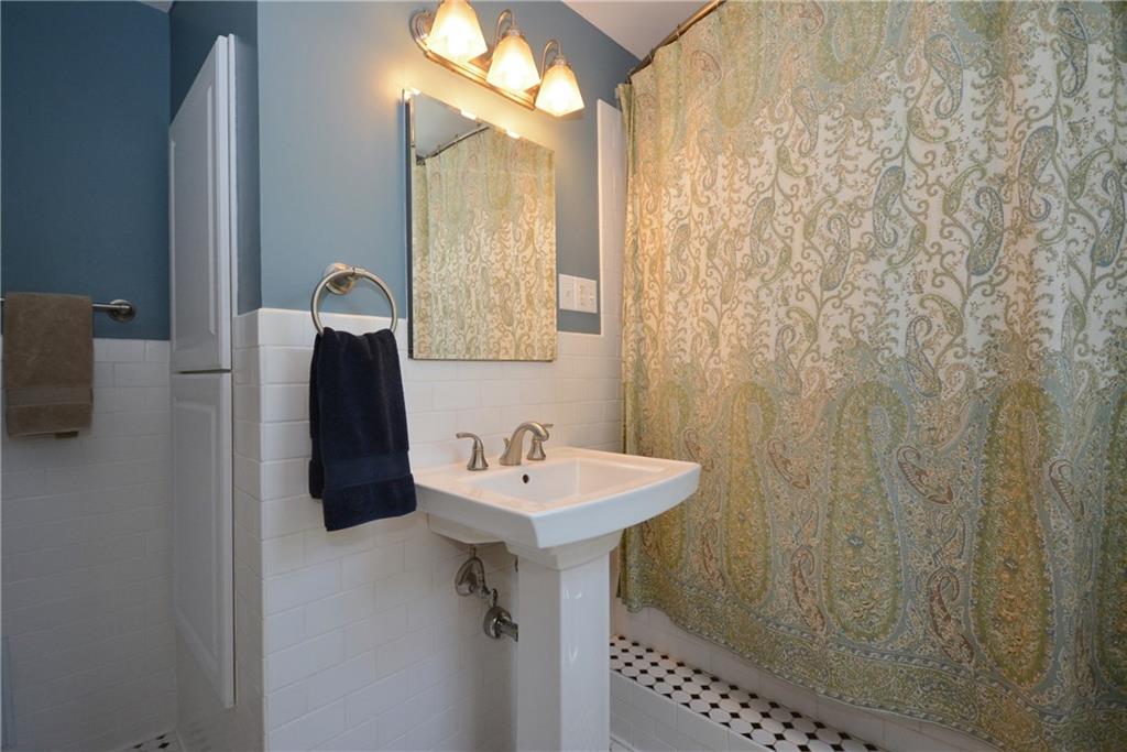 1329 Brinton Road Forest Hills, PA 15221 - Photo 14 of 24 Subway tile, black and white floor tiles, new fixtures and pedestal sink complete this renovated bathroom.