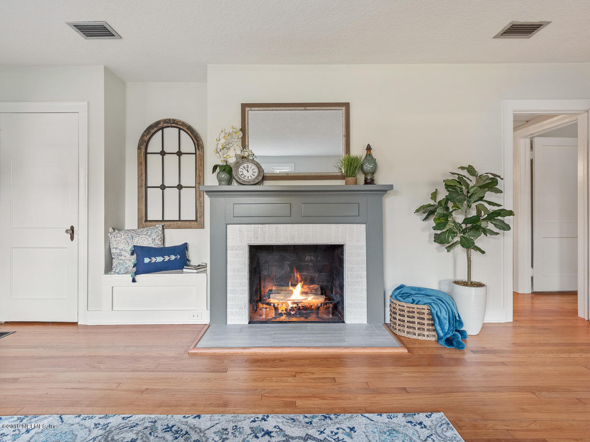 3981 Gadsden Road Jacksonville, FL 32207 - Photo 8 of 34 a living room with a fireplace and potted plants
