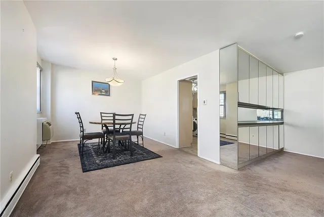 a view of kitchen with refrigerator and dining table