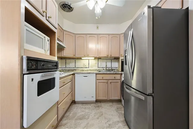 a kitchen with stainless steel appliances a refrigerator sink and cabinets