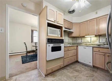 a kitchen with cabinets and stainless steel appliances
