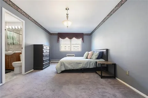 a bed room with a bed and a large window