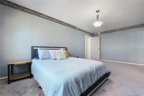 a bedroom with a bed and a ceiling fan