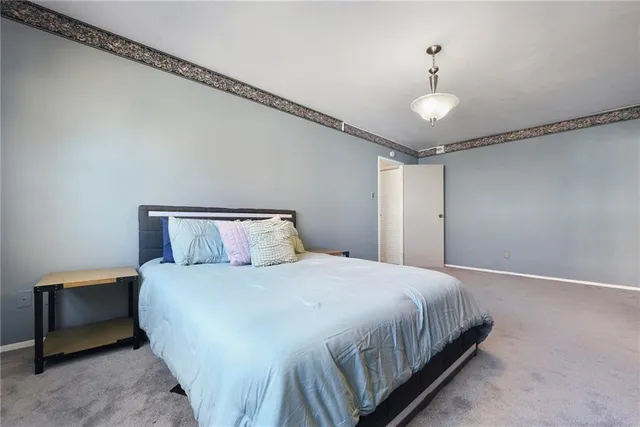 a bedroom with a bed and a ceiling fan