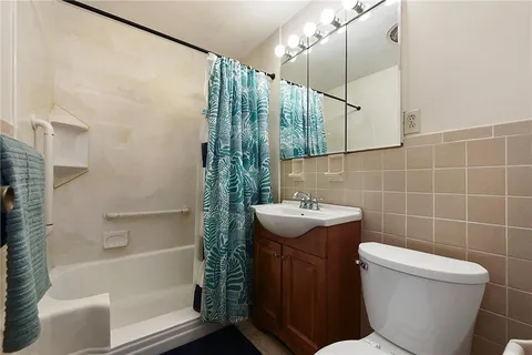 a bathroom with a sink toilet and shower