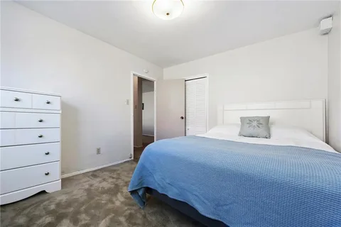 a bedroom with a bed and a cabinets