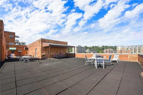 a view of a patio with a table and chairs